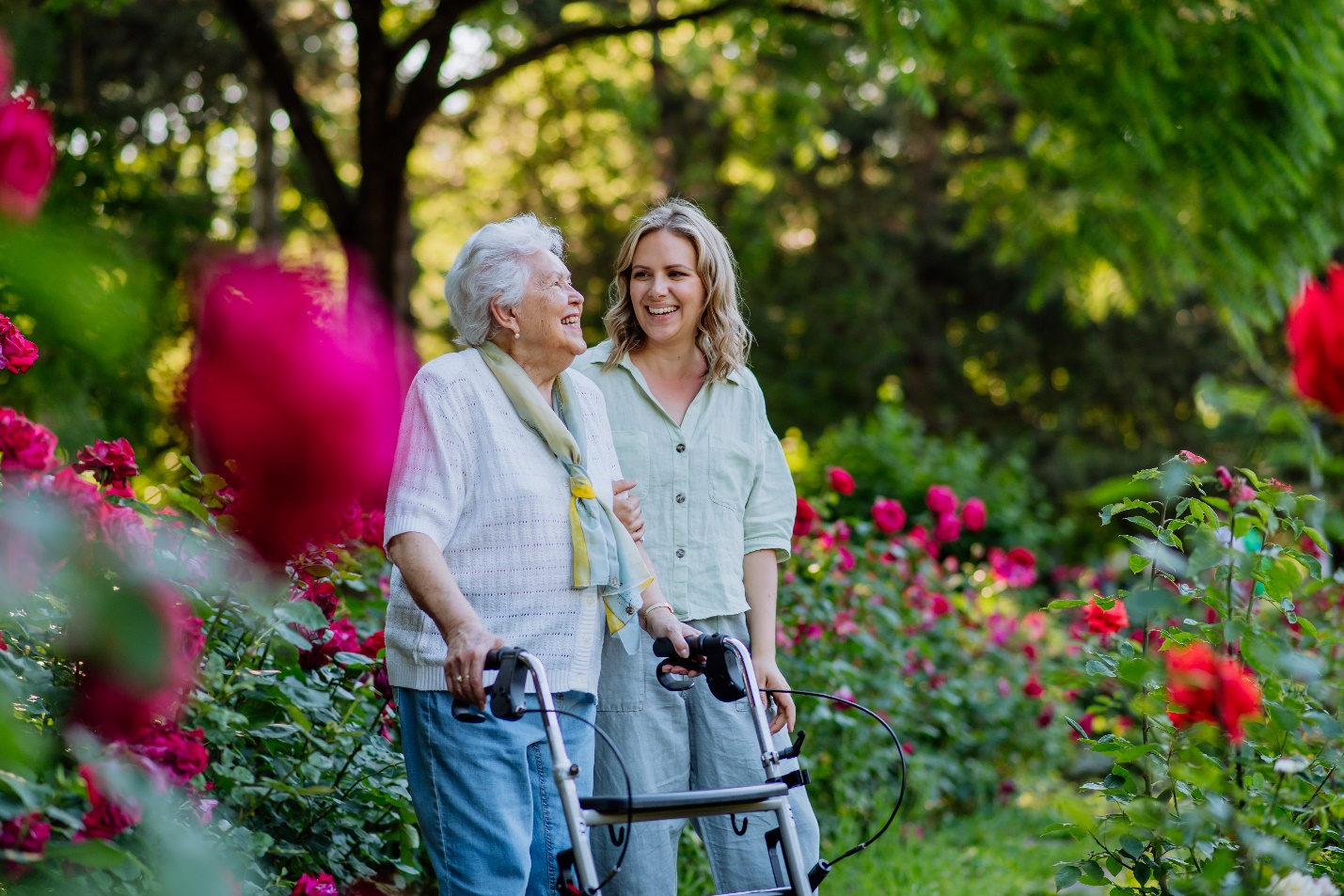 A person and a young person walking with a walker

Description automatically generated