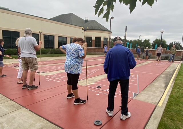 people playing shuffleboard outside