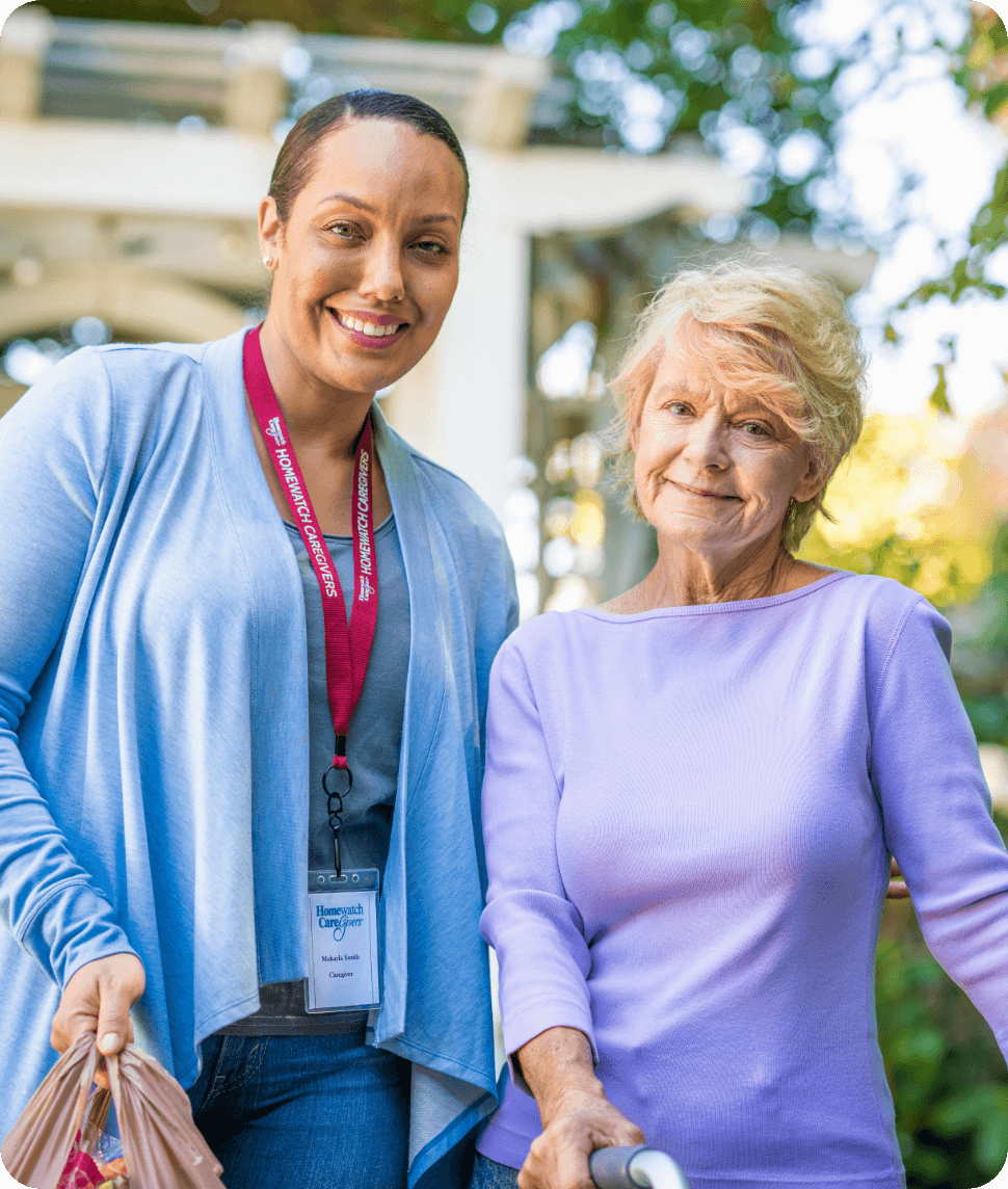 A caregiver with an elderly woman smiling