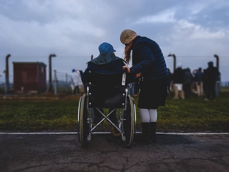 a person in a wheelchair with family