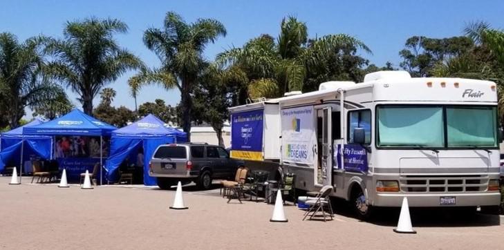 booths and large bus set up for an event
