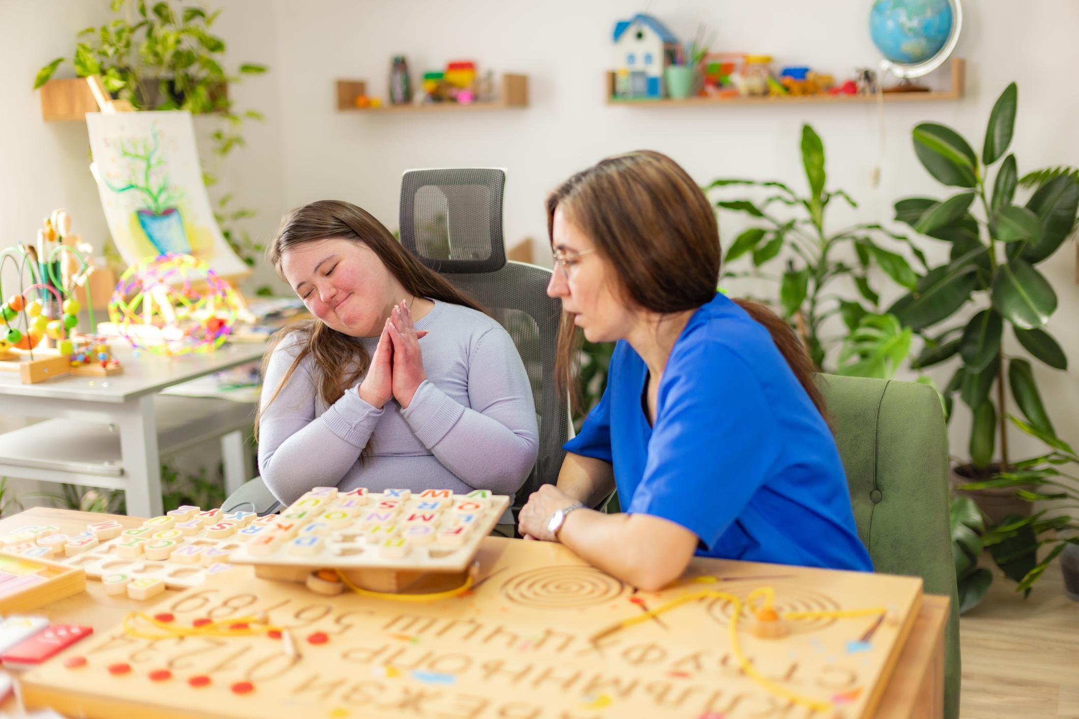 younger woman with developmental disabilities with female caregiver