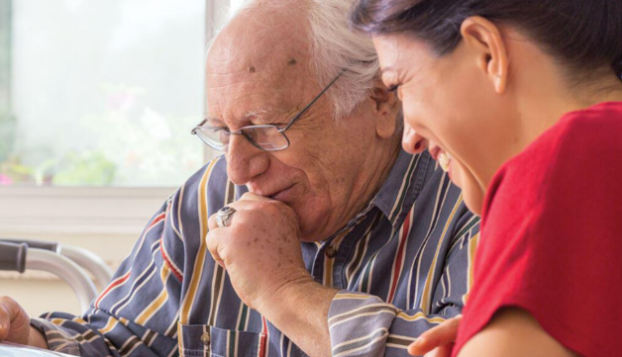 man and woman looking at something and smiling