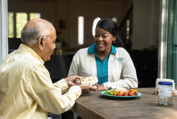 nurse smiling at man while he takes pills out of holder