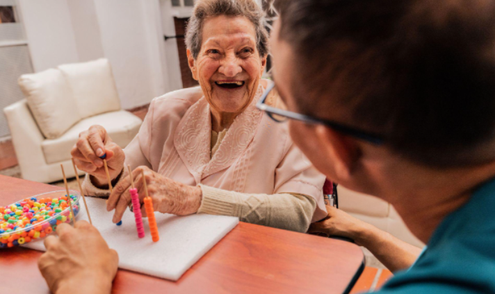woman playing with beads and smiling at man
