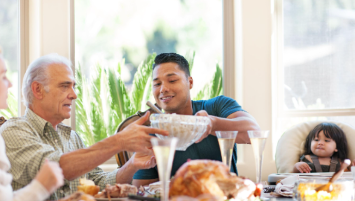 adults passing food at table