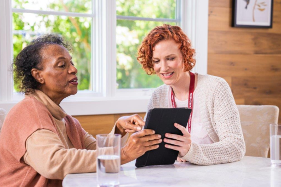 women looking at tablet together