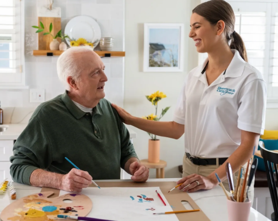 caregiver smiling at man painting