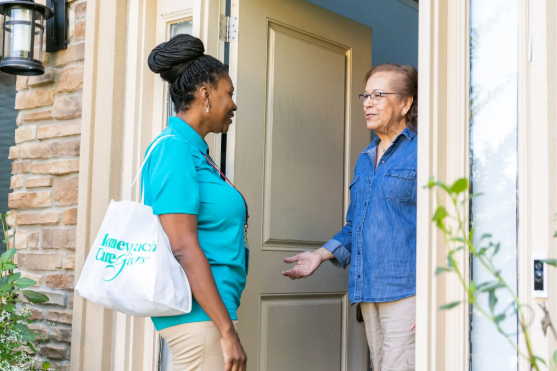 women talking at front door