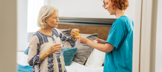 woman grabbing pills from bottle