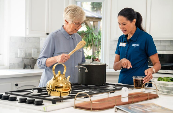 two women staring at pot on stove