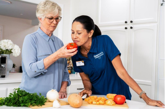 woman smelling tomato