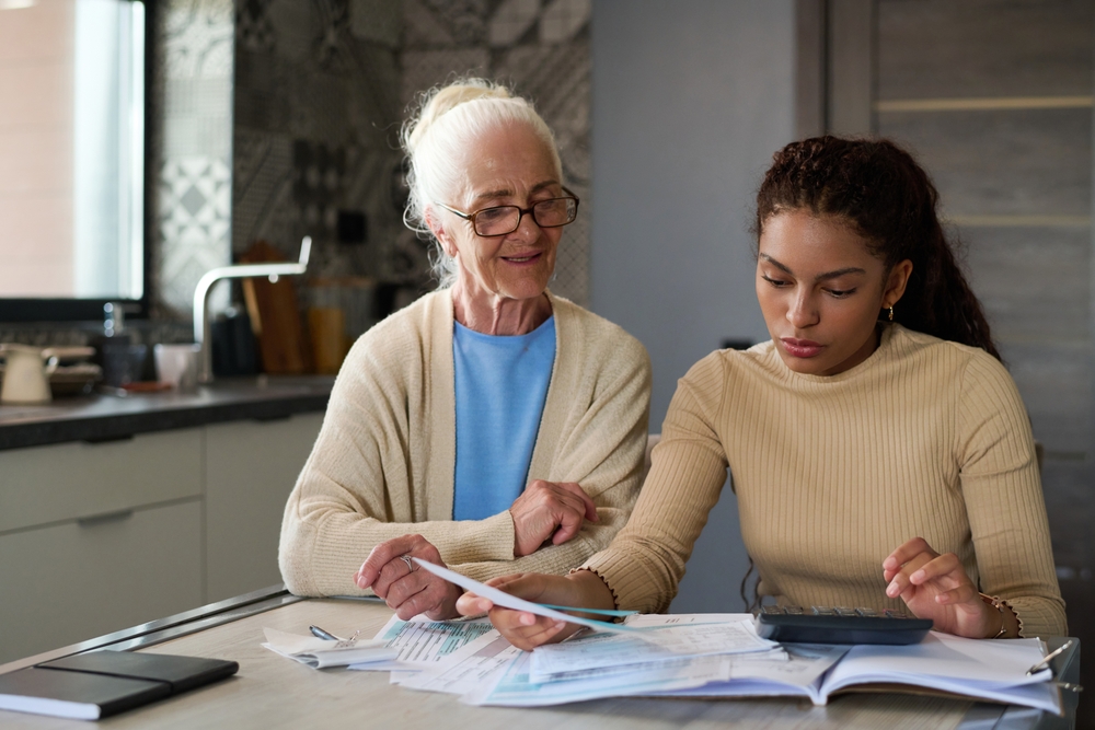 Elderly woman and young woman reviewing papers