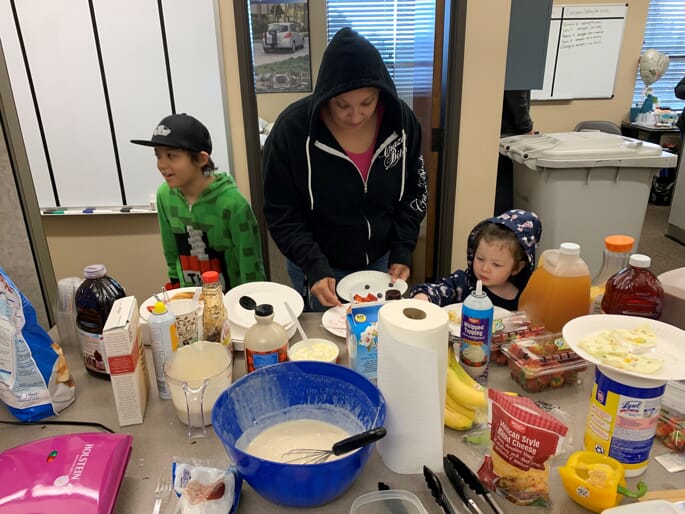 caregiver with children at appreciation breakfast