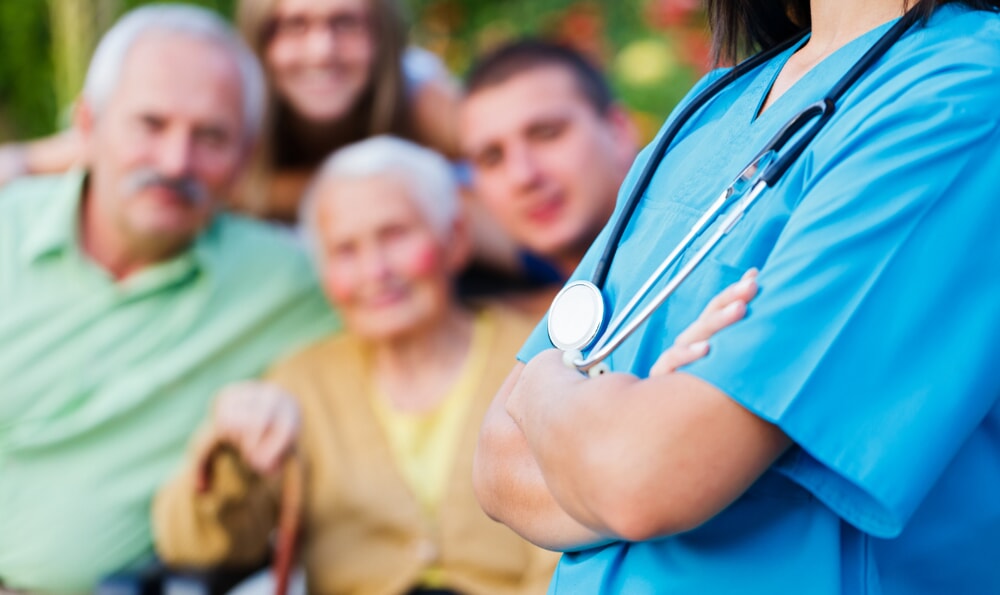 close up of doctor with older people in background