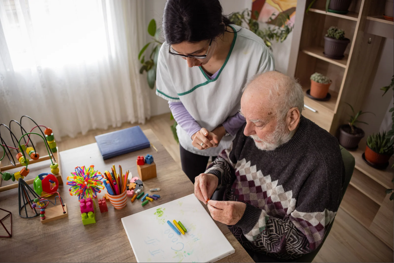 senior alzheimer's disease doing memory activities with caregiver at home